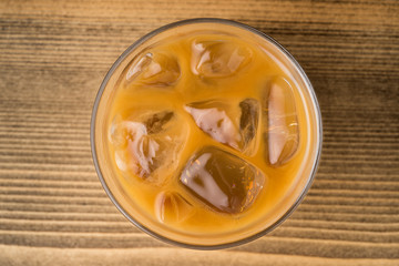 Top view of iced coffee on wooden table