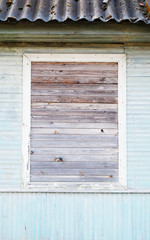 Obraz na płótnie Canvas neatly boarded up window in a wooden house