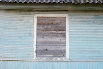 neatly boarded up window in a wooden house