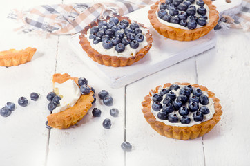 Sweet Blueberry tarts on  white wooden background