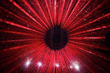 Red ribbons and petals hang from the ring on the ceiling