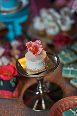 Steel dish and little pink cake on it