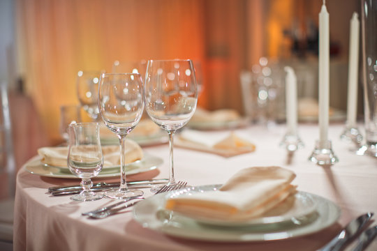 Sparkling glasses stand by plate on dinner table