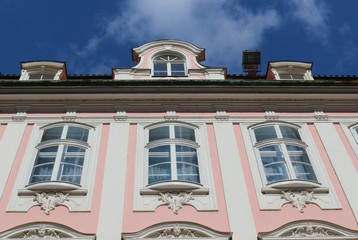 View towards the sky and the top of a  rose-red magnificent historical building in the Maximilian street in Augsburg, Germany