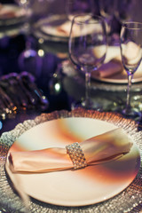 Serviette in the ring of pearls lies on dinner plate