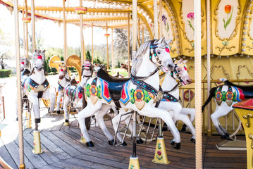Fototapeta na wymiar Carousel with horses in a children's amusement park.