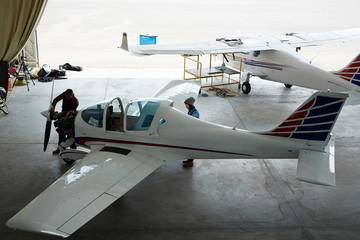 Wide angle shot of jet planes repair in maintenance hangar - obrazy, fototapety, plakaty