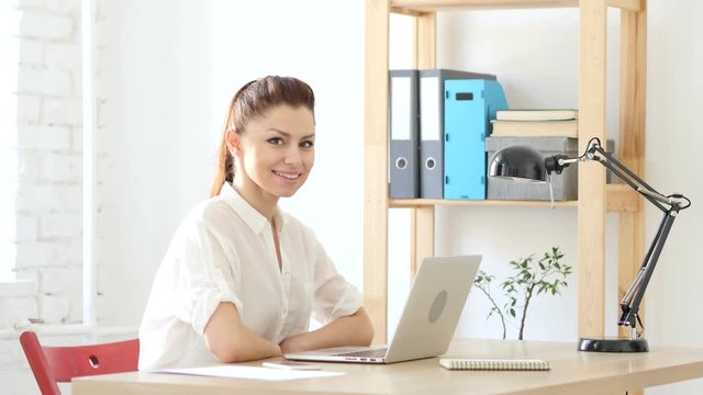 Designer Woman  at Work Smiling toward Camera