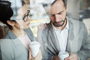 Businesswoman reassuring her colleague during coffee-break