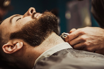Obraz na płótnie Canvas Barber's beard cuts a hipster
