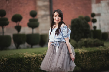 Fototapeta premium Young Asians girl with modern dress posing in an old Krakow