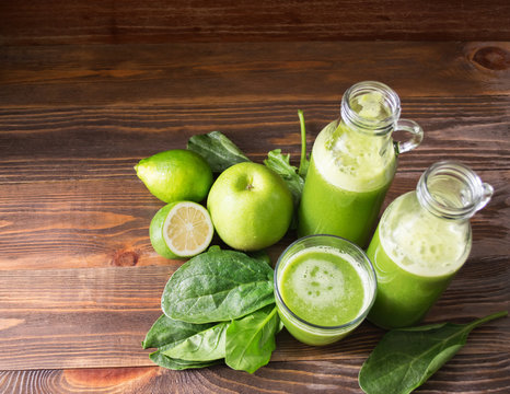 Fresh juice, smoothies, green Apple, lime and spinach in glass small bottles