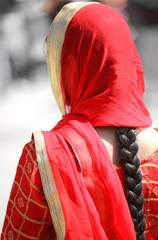 young indian woman with long black hair and red dress