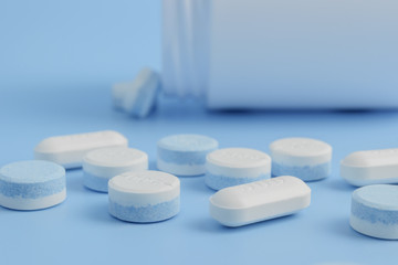 Fototapeta na wymiar white pills on the soft blue background with soft focus style. paracetamol 500 mg.