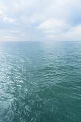 Distant clouds on calm sea.