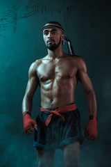 Fototapeta na wymiar Muay Thai athlete training at Thai boxing indoors, ultimate fight concept