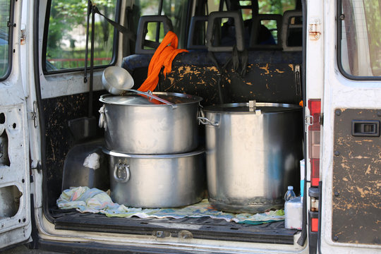 large pots for transporting food in a van of non-governmental or