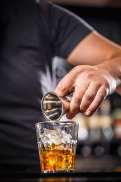 Bartender pouring alcohol