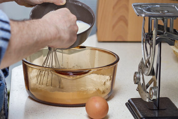a person preparing pancakes in a kitchen