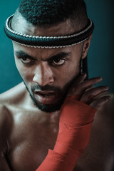 Obraz premium Muay Thai athlete training at Thai boxing indoors, ultimate fight concept