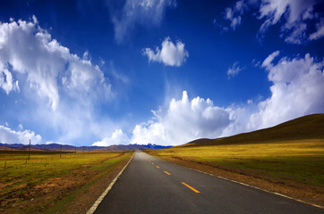 Winding road along the green meadows