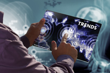 Business, Technology, Internet and network concept. Young businessman working on a virtual screen of the future and sees the inscription: Trends