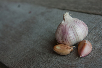 Fresh young garlic from a home garden on wooden boards.