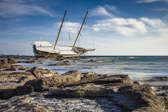 A shipwrecked Boat in Calasetta, on the coast of south Sardinia where is sitting even today