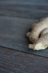 Fototapeta premium raw ginger root on rustic wooden background.