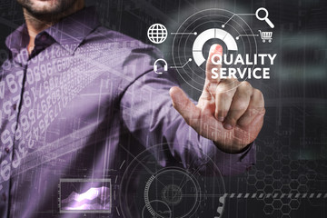 Business, Technology, Internet and network concept. Young businessman working on a virtual screen of the future and sees the inscription: Quality service
