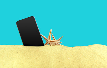 Fototapeta na wymiar Phone on the sand