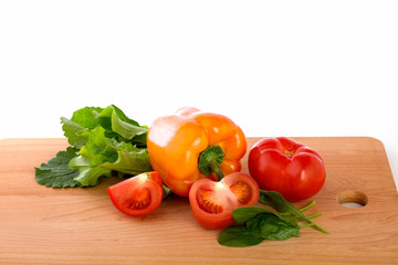 Fesh tomatoes and pepper on the wooden background