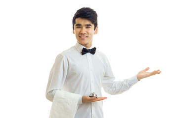 handsome young waiter extended a hand to the side and smiling