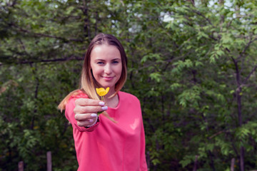 Beautiful girl holding a flower.