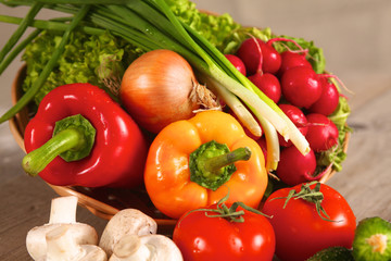 Composition with assorted raw organic vegetables wooden table