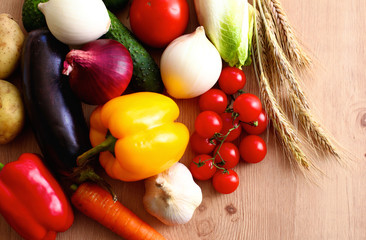 Composition with assorted raw organic vegetables wooden table