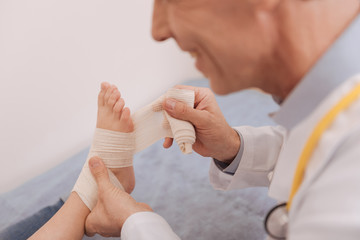 Pleasant friendly doctor making sure patient feeling fine