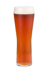 A glass of refreshing light beer. Golden beer with foam.