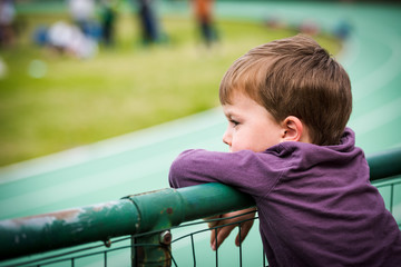 Child watching sports game in stadium