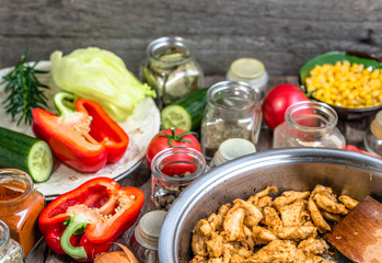 Cooking chicken with vegetables, preparing kebab or tortilla wrap