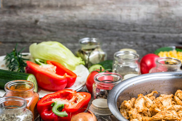 Cooking chicken with vegetables, preparing kebab or tortilla wrap