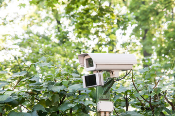 Security camera on the blue wall.
