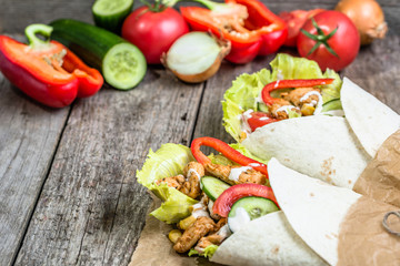 Tortilla with chicken and vegetables, mexican cuisine fast food