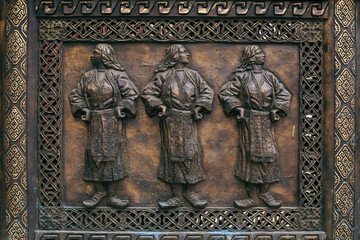 Bronze carving relief with three women figures  in traditional Macedonian folkloric dresses