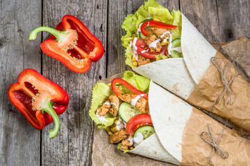 Tortilla wraps with fresh vegetables and grilled chicken meat, tex-mex cuisine
