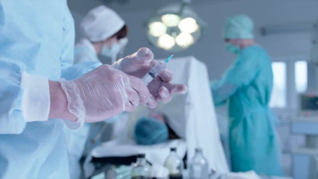 Surgeon and nurses operating the patient 