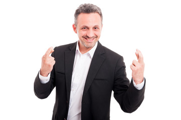 Handsome young man with crossed finger