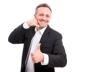 Cheerful smiling man making call me gesture