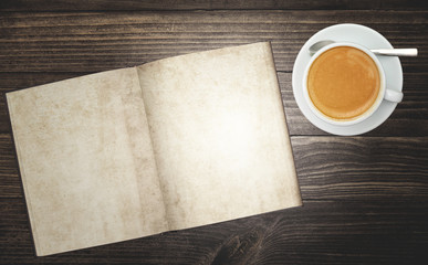Obraz na płótnie Canvas top view of rustic wood table surface with blank notebook diary and a delicious cup of hot coffee