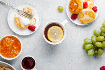 Morning atmosphere. Healthy breakfast with porridge, oatmeal, pancakes, lots of berries and snacks on blue rustic background. Copy space